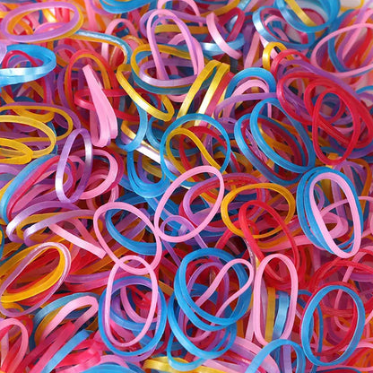 Multicolor rubber bands effectively bundling pencils and electronic cords on a desk.